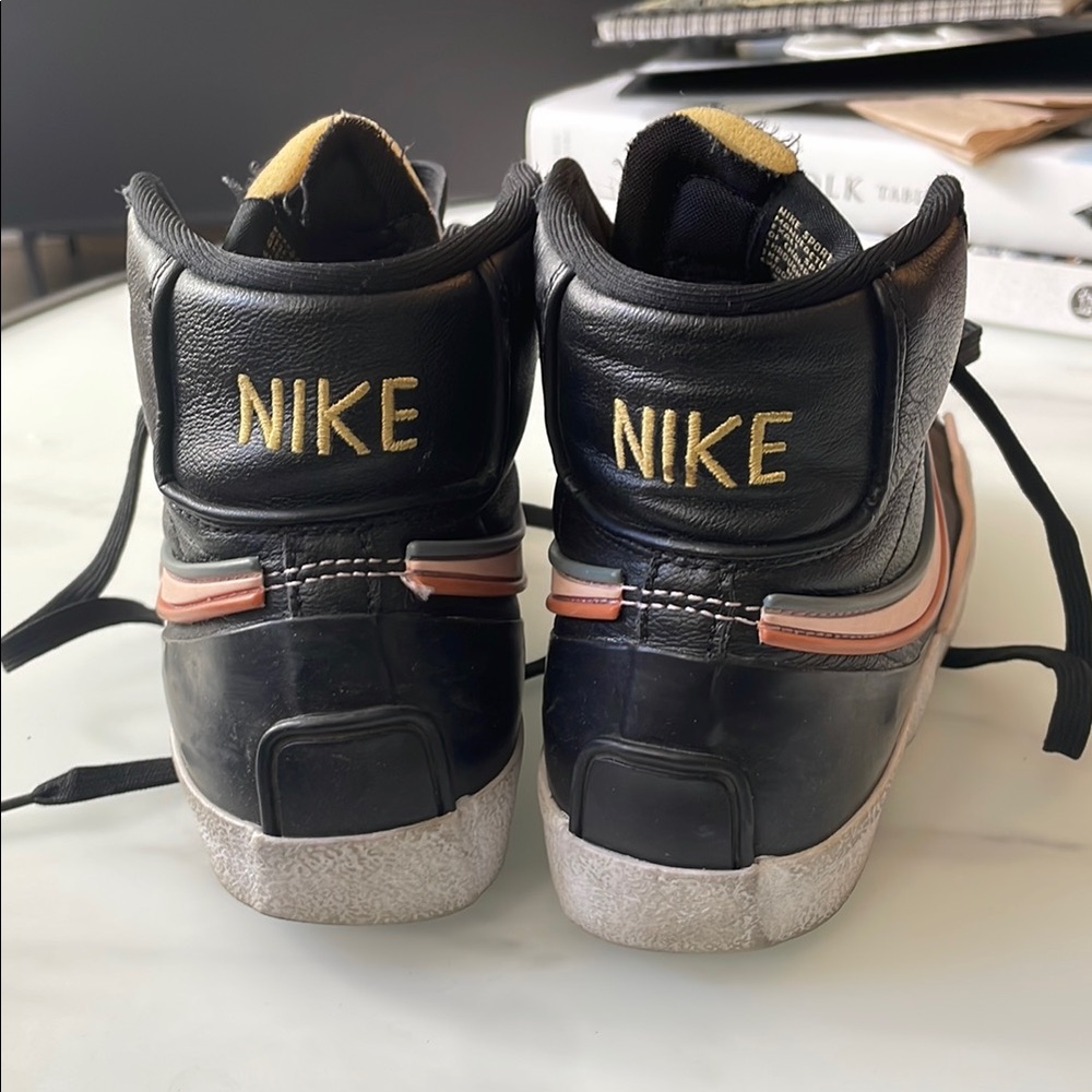 Nike Black High-Top Sneakers with Orange Swoosh